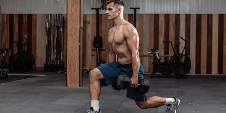 Man Doing Lunges With Heavy Dumbbells