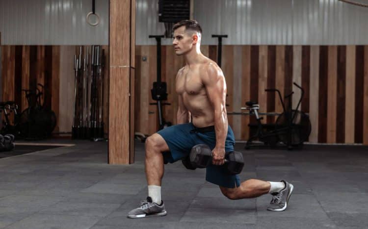 Man Doing Lunges With Heavy Dumbbells