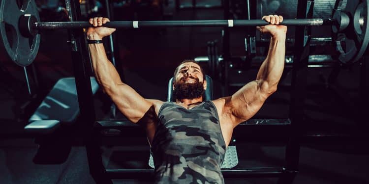 Man Doing Bench Press In Gym